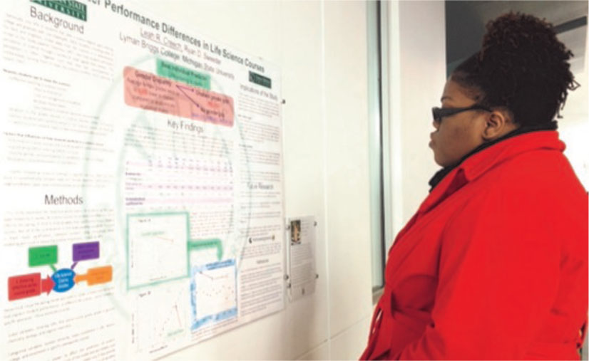 Student observes showcase poster